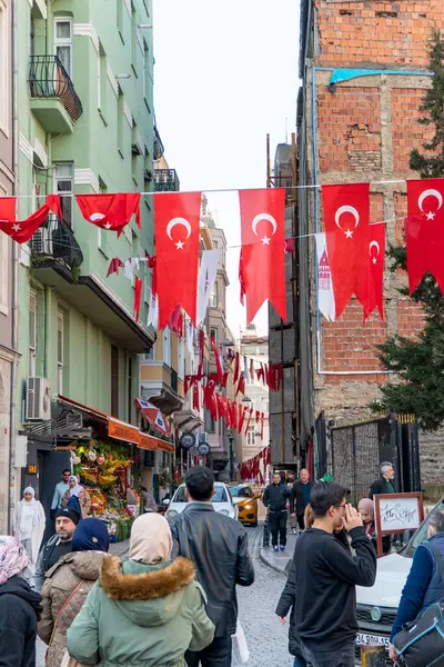 Crowded street with national turkish flags nex to Galata Tower, Istanbul, Turkey