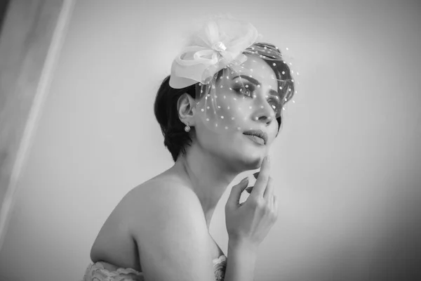 Stock image Studio shot. Close-up black and white shot of luxurious bride in veil hat posing for camera in the mirror