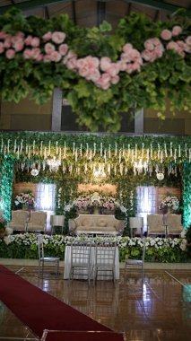 Endonezya 'da pelaminan adı verilen düğün sahnesi, çeşitli çiçeklerle süslenmiş.