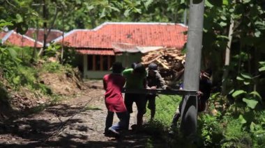 CIANJUR, INDONEZYA - 17 Ekim 2015: Uzak bölgelerde elektrik direklerinin ve kabloların inşasına sakinlerin karşılıklı işbirliğiyle yardımcı olunur
