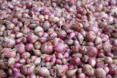 Red onion in a stall in Ciwidey traditional market in Bandung, Indonesia. clipart