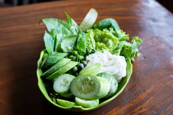 Lalapan or fresh raw vegetables basket. eaten with chili sauce as a complementary food. authentic indonesian food