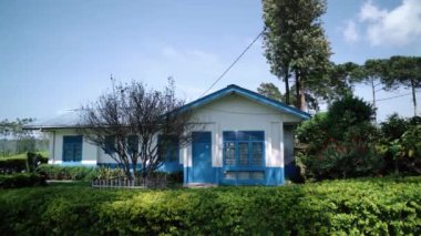 CIWIDEY, İNDONEZYA - 30 Ekim 2024: Gün boyunca doğal atmosferi olan mavi ve beyaz çay toplayıcıları evleri