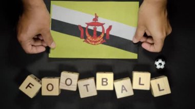Futbol unvanlı Brunei bayrağı. futbol konsepti