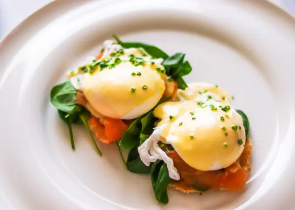 stock image Luxury breakfast, brunch and food recipe, poached eggs with salmon and greens on gluten-free toast for restaurant menu and gastronomy branding