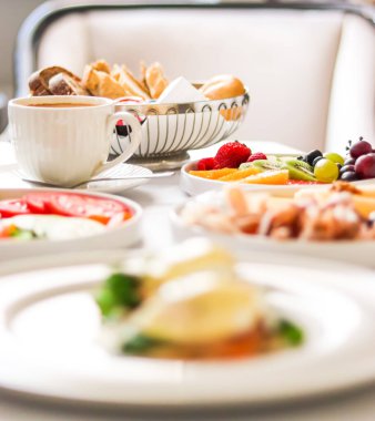 Lüks otel ve beş yıldızlı oda servisi, çeşitli yemek tabakları, ekmek ve kahve seyahat ve konukseverlik markası olarak oda kahvaltısı.