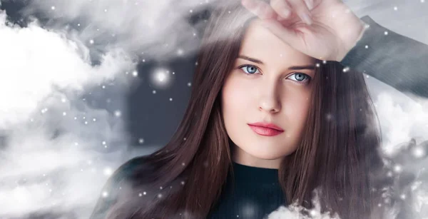 stock image Winter beauty, Christmas time and happy holidays, beautiful woman with long hairstyle and natural make-up behind frozen window, snowing snow design as xmas, New Year and holiday lifestyle portrait