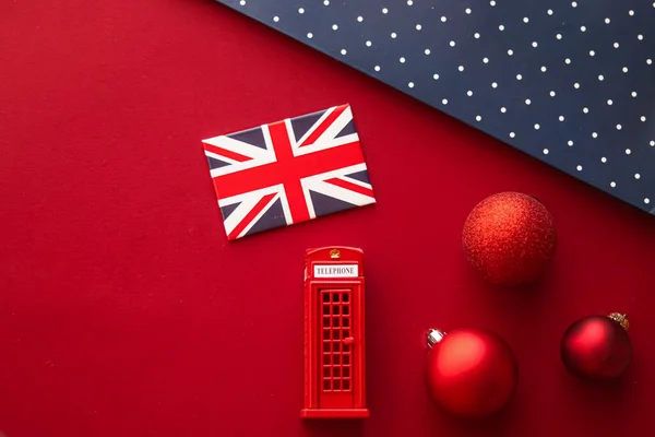 Christmas holiday tradition in United Kingdom and happy holidays flat lay, british flag, London telephone box and xmas decoration on festive red background as flatlay design, top view