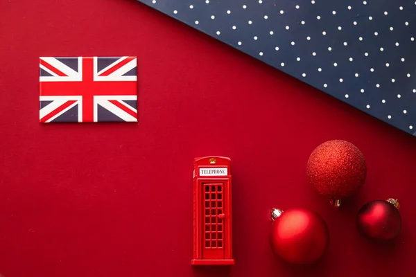 Christmas holiday tradition in United Kingdom and happy holidays flat lay, british flag, London telephone box and xmas decoration on festive red background as flatlay design, top view