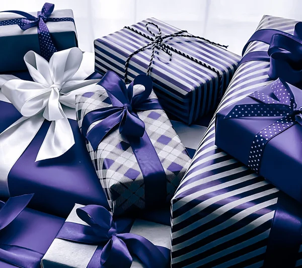 Holiday gifts and wrapped luxury presents, purple gift boxes as surprise present for birthday, Christmas, New Year, Valentines Day, boxing day, wedding and holidays shopping or beauty box delivery