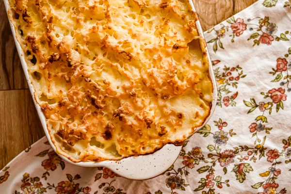 Comfort food and traditional English cuisine, oven baked fish pie on rustic wooden table in countryside kitchen, homemade recipe idea