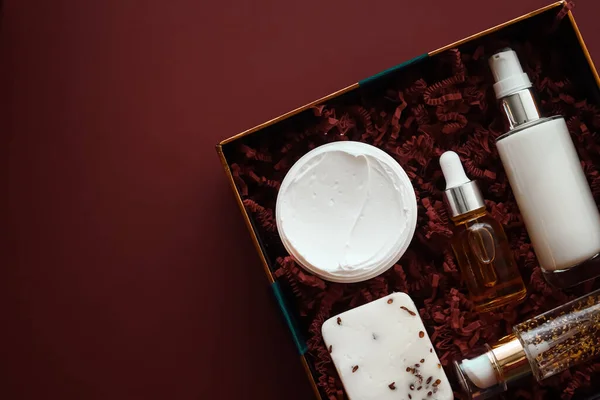 Beauty box subscription package and luxury skincare products, cosmetic body care product flat lay on mahogany background, wellness cosmetics as holiday gift, online shopping delivery, flatlay view