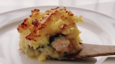 Comfort food and traditional English cuisine, portion of fish pie served on white plate, homemade recipe idea