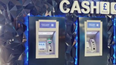 Luton, Bedfordshire, England, United Kingdom circa January 2023: Cash machine, bank ATM and currency exchange at London Luton Airport