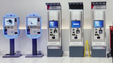 Luton, Bedfordshire, England, United Kingdom circa January 2023: Cash machine, bank ATM and currency exchange at London Luton Airport
