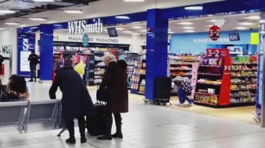 Luton, Bedfordshire, England, United Kingdom circa January 2023: Duty Free stores and coffee shops at London Luton Airport