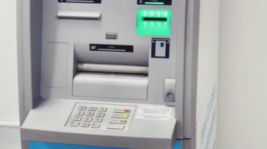 Luton, Bedfordshire, England, United Kingdom circa January 2023: Cash machine, bank ATM and currency exchange at London Luton Airport