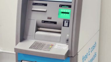 Luton, Bedfordshire, England, United Kingdom circa January 2023: Cash machine, bank ATM and currency exchange at London Luton Airport