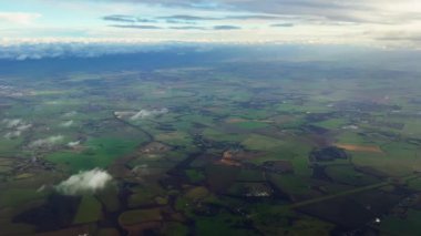 Aerial view of rolling hills of the English countryside landscape, beautiful nature, rural fields and green pastures on a sunny day in England, United Kingdom.