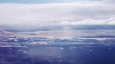 Glorious dreamy sky over aerial view of England, United Kingdom, sun rays and clouds at sunrise or sunset in pastel colours as video background.
