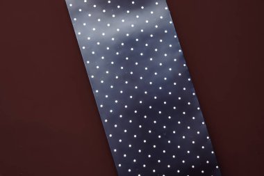 Abstract blue polka dot background on chocolate backdrop.