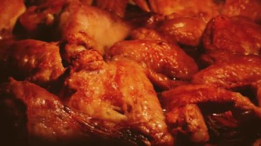Chicken wings being roasted in the oven.