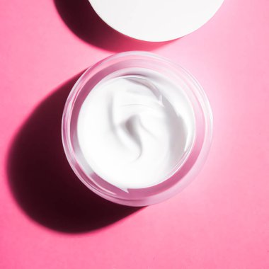 Skincare face cream jar on pink background, generative AI.