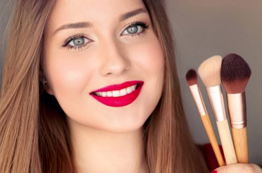 Beauty, makeup and cosmetics, face portrait of beautiful woman with make-up brushes, luxury cosmetic product, makeup artist or beauty blogger concept.