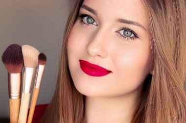 Beauty, makeup and cosmetics, face portrait of beautiful woman with make-up brushes, luxury cosmetic product, makeup artist or beauty blogger concept.