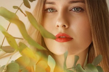 Beauty, makeup and hairstyle, face portrait of beautiful woman with green leaves branch, red lipstick makeup for skincare cosmetics and fashion look idea clipart