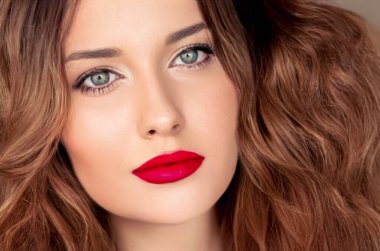 Güzellik, makyaj ve saç stili, güzel bir kadının yüz portresi, kırmızı ruj makyajı ve cilt makyajı, saç bakımı, cazibe stili ve moda fikri.