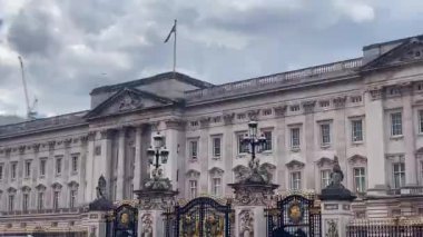 Karmaşık detaylar ve kraliyet amblemleriyle süslenmiş Buckingham Sarayı 'nın büyük cephesi Britanya' nın zengin monarşisinin ağır çekim sembolü olarak duruyor.