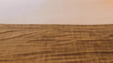 Yumuşak beyaz yastıkları olan rahat bir yatak odası dekoratif bir yastık ve sıcak bir aydınlatma, rahatlatıcı ve davetkar bir atmosfer sunuyor.