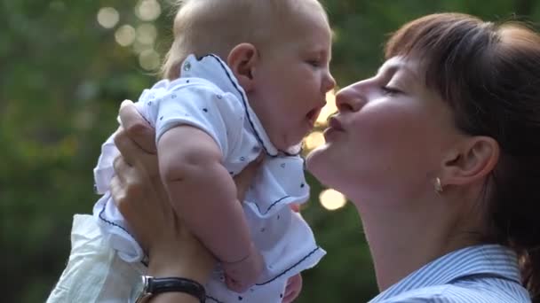 Close Mom Lifts Little Baby Girl Kissing Her Cheek Slow — Stock Video