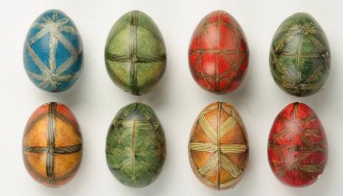 A vibrant collection of Eastern European Easter eggs showcases intricate designs and bold colors. The eggs are arranged in a grid pattern, featuring hues of blue, green, red, and orange. clipart