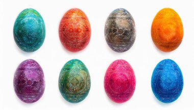 A vibrant collection of Eastern European Easter eggs is displayed against a pure white background. Each egg showcases intricate designs, with rich colors like blue, orange, purple, and pink. clipart