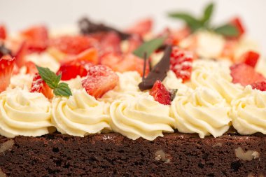 Deliciously rich cake brownie slice with Chantilly cream and fresh strawberry.