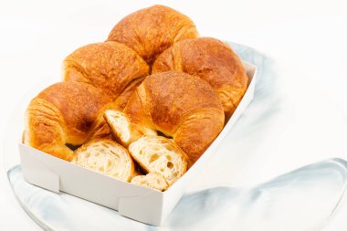 Freshly baked golden brown plain butter croissants.