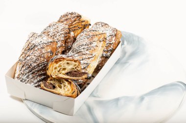 Mouth watering dark chocolate croissants topped with fondant and icing sugar.