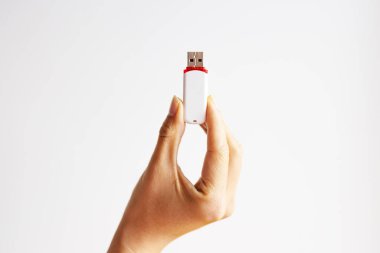 Cropped shot of an unrecognizable woman hand showing a pen drive isolated on a white background. clipart