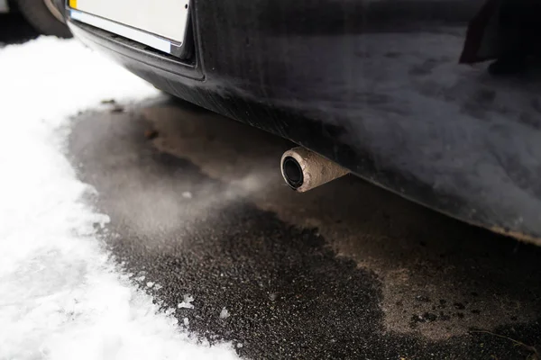 pollution from car exhaust in the city in winter. Smoke from cars on a cold winter day