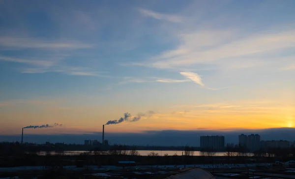 우크라 이나의 시에서 석양에 대기를 뿜어내는 연기가 흐르는 발전소 파이프 — 스톡 사진