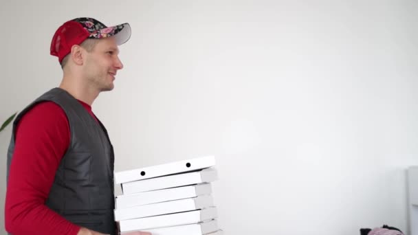 Pizza Levering Koerier Passeert Witte Kartonnen Pizzadoos Tegen Witte Achtergrond — Stockvideo