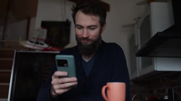 Happy Man Drinking Cup Coffee Home Young Man Using Smartphone — Stock Video