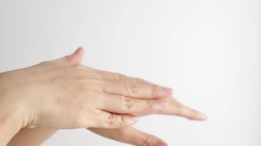 Female hands care. Close up shot of asian lady applying cream on hand skin, slow motion