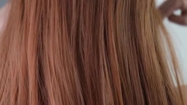 Gorgeous falling red hair in slow motion. Rear view.