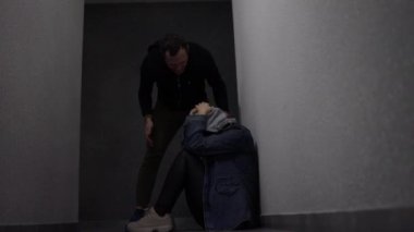 Black and blurry silhouettes. Assault and beating of a woman. Violence over the weak. Robbery and fight.