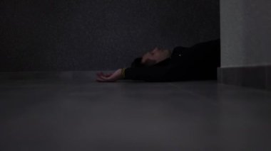 corpse of man and drags body by legs from room. Elimination of traces of crime. criminal pulls corpse out of room. 