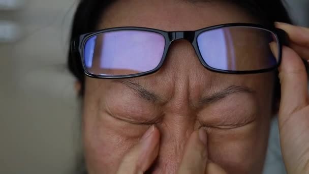 Tired Asian Woman Massaging Her Nose Bridge Holding Glasses Living — Stockvideo