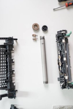 Specialist repairs the printer cartridge, fuser unit close-up. printer repair technician.